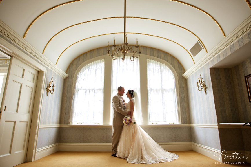 Wedding photo of a bride and groom in a ballroom at The Davenport Hotel