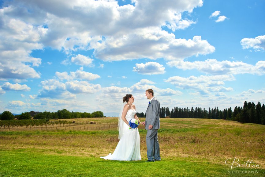 Wedding photo of a gride and groom in a field at High Country Orchard in Green Bluff