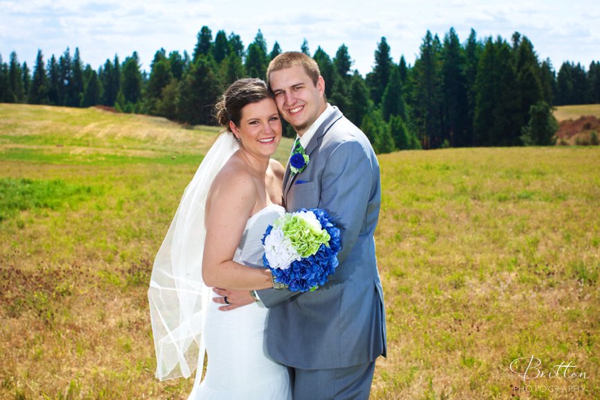 Wedding photo of a gride and groom in a field at High Country Orchard in Green Bluff